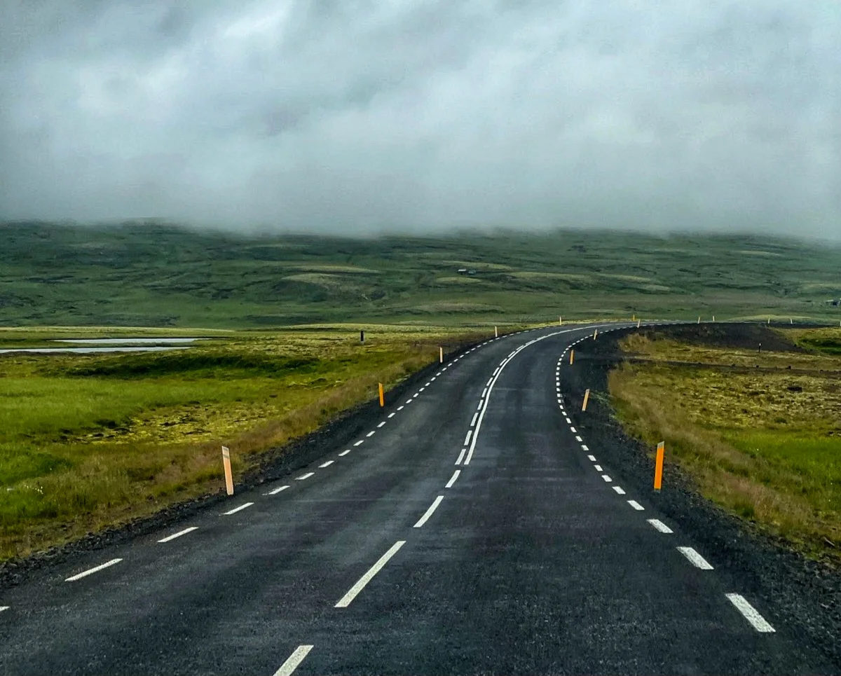 A road disappearing into the fog, the freedom of a trip without a rigid plan.