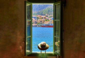 travel-habits-window-suitcase-sea-view