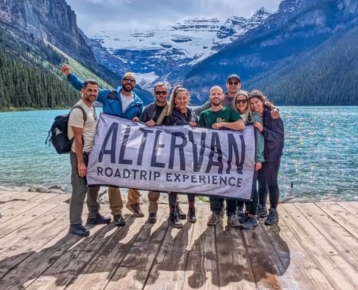 The Altervan flag in front of a lake and mountains